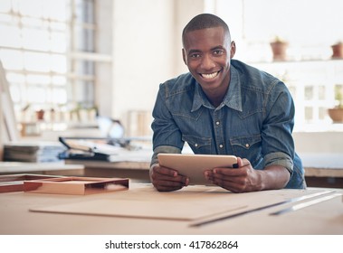 Small Business Owner Of African Descent In Studio With Tablet