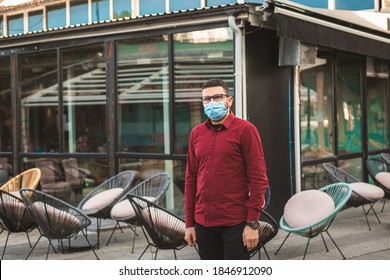 Small Business Owner With Mask Standing In Front Of Empty Coffee Shop With No People Due To Covid-19