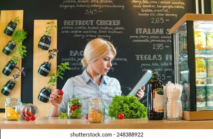 Small Business Owner Reading The Recipe On A Digital Tablet