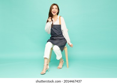 Small Business Owner Sme Asian Woman Sitting On Wood Chair Isolated On Green Background 