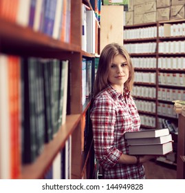 Small Business Owner. Successful Commerce Woman In Proper Book Shop Standing With Books.  Young Ambitious Female Retailer Among Print Shelf.