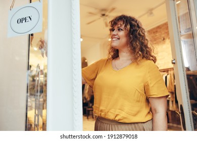 Small Business Owner Turning The Door Sign To Open. Fashion Boutique Owner Opening Her Store For Business.