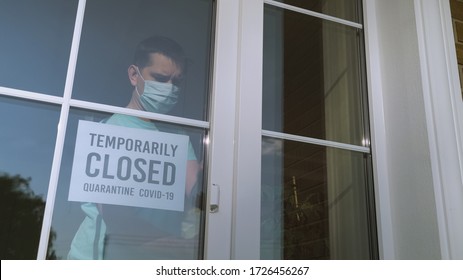 Small Business Owner Turns The Sign On Her Storefront From Open To Closed Because Of Coronavirus Pandemic. Sign In A Shop Window: TEMPORARILY CLOSED. Covid-19 Isolation And Closed Shops.