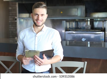 Small business owner working at his cafe
