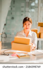 Small Business Owners In Asia Working From Home Online Marketing Packaging And Delivery Scene, SME Entrepreneur Or Independent Woman. Parcel Delivery Concept, Vertical Image