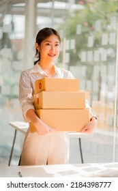 Small Business Owners In Asia Working From Home Online Marketing Packaging And Delivery Scene, SME Entrepreneur Or Independent Woman. Parcel Delivery Concept, Vertical Image