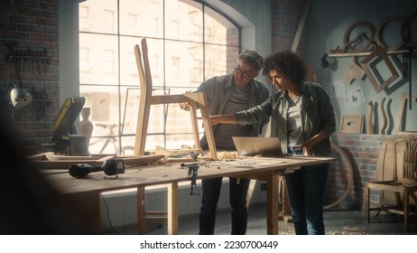 Small Business Owners of a Furniture Workshop Using Laptop Computer and Discussing the Design of a New Wooden Chair. Middle Age Carpenter and a Young Female Apprentice Working in Loft Studio. - Powered by Shutterstock