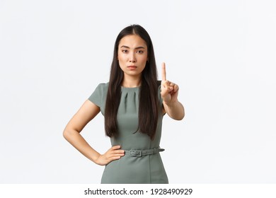 Small Business Owners, Women Entrepreneurs Concept. Strict Serious Asian Businesswoman In Dress Scolding Employee, Looking Disappointed And Shaking Finger, Disagree, Prohibit Action