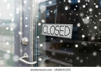 Small Business, Pandemic And Service Concept - Glass Door Of Closed Shop Or Office In Winter Over Snow