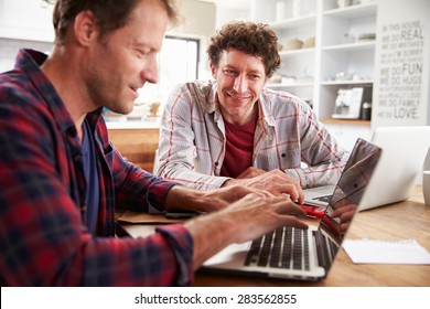 Small Business Partners Using Computers At Home