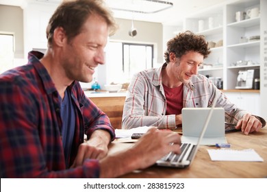 Small Business Partners Using Computers At Home