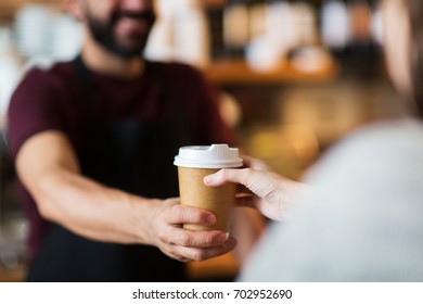 small business, people and service concept - man or bartender serving customer at coffee shop - Powered by Shutterstock