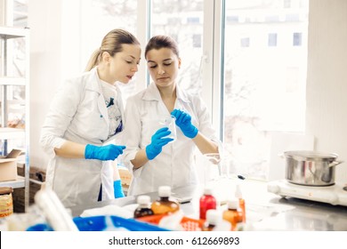 Small business people at work. Two young womens are working at their laboratory of cosmetic production.