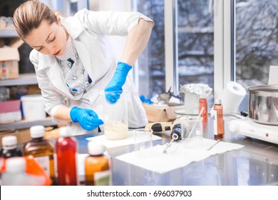 Small business people at work. Young woman working at the laboratory of cosmetic production.