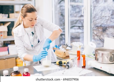 Small business people at work. Young woman working at the laboratory of cosmetic production.