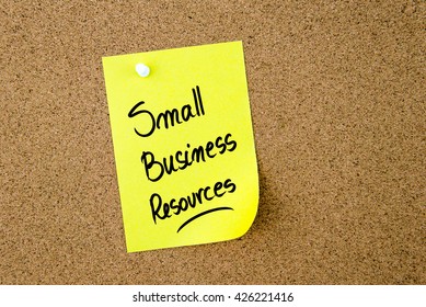 Small Business Resources Written On Yellow Paper Note Pinned On Cork Board With White Thumbtack, Copy Space Available