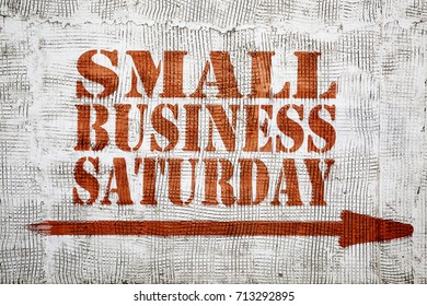 Small Business Saturday  - Graffiti Sign With Arrow On Stucco Wall