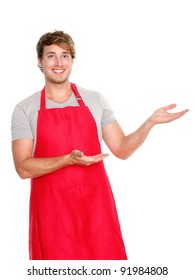 Small Business Shop Owner Showing Wearing Red Apron. Happy Smiling Caucasian Man Presenting Isolated On White Background.