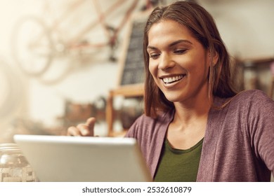 Small business, woman and happy with tablet at bicycle shop on break, social media and networking. Female person, store assistant and smile as employee for with reviews for service and repairs - Powered by Shutterstock