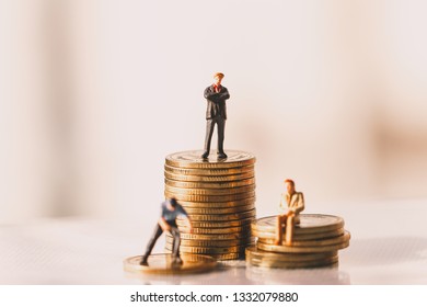 Small businessman figures standing on turning poing. money saving and 
 investment. retirement. Income and economic inequality concept. Inequality in social class. - Powered by Shutterstock