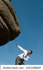 Small Businessman Trying To Avoid Massive Boulder Rolling Down Over Him