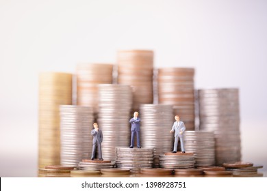 Small businessmans figures standing on turning poing. The concept of role conflict in society. money saving and Investment concept. Business finance. Inequality and social class. - Shutterstock ID 1398928751