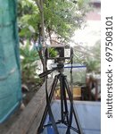 A small camera and a drum stand are placed on the table.