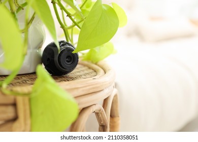 Small Camera Hidden Near Houseplant On Table In Room