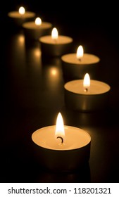 Small candles burning in the dark. Holiday/ romance/ religion/ meditation concept