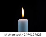 small candles lit with calm flame isolated black background