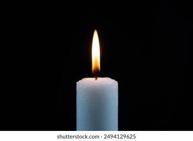 small candles lit with calm flame isolated black background - Powered by Shutterstock