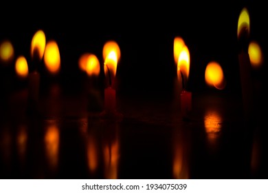 Small Candles Lit In Dark 