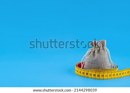 a small canvas bag wrapping with a centimetre on blue background Foto stock © 