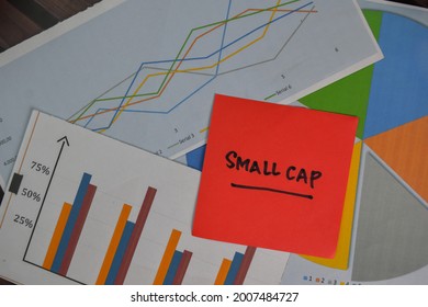 Small Cap Write On Sticky Notes Isolated On Wooden Table.