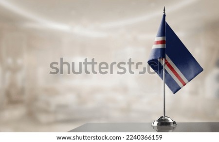 A small Cape Verde flag on an abstract blurry background