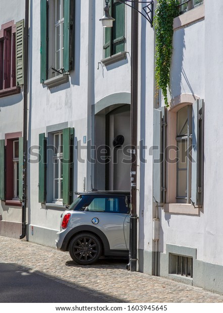 Small car entering narrow passageway in\
Basel, Switzerland