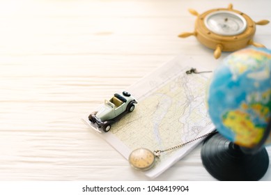 Small car on the map. The concept of travel