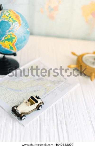 Small car on the\
map. The concept of\
travel