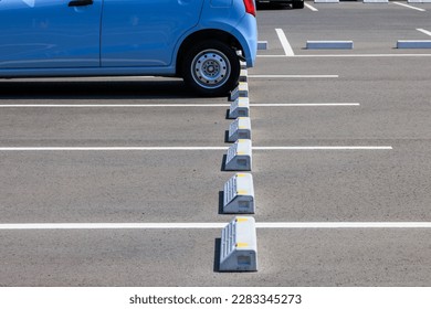 A small car parked in a parking lot - Shutterstock ID 2283345273