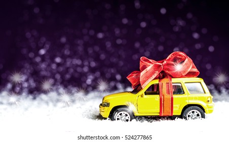 Small Car With Red Decorative Bow In Snow