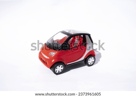 Small car toy.
Car red in isolated on a white background. 
Photo