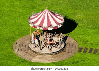 the small carousel in green grass