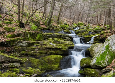 a small cascade flowing over rocks on falls brook trail in West Hartland Connecticut.