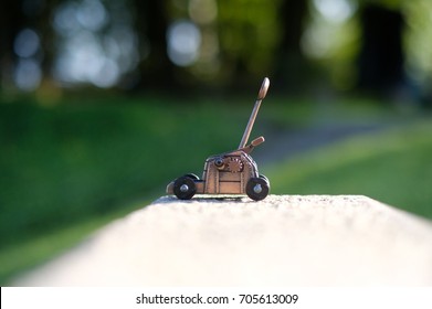 Small Catapult Toy Against Natural Green Blured Background