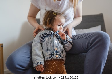 Small Caucasian Baby Girl Infant Child With Her Mother Dressing Or Undressing Small Daughter At Home Childhood Parenthood And Growing Up Family Concept Real People Copy Space