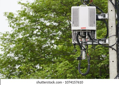 Small Cell 3G, 4G, 5G System. Macro Base Station or Base Transceiver Station on Electricity post. Development of communication system in urban area with green environment.