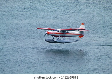 Small Cessna Plane Landing On The Alaska Sea