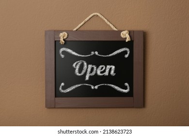 Small Chalk Board With Word Open On Brown Wall