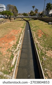 Small channeled river and grass fields in São João del Rei, Minas Gerais state, Brazil