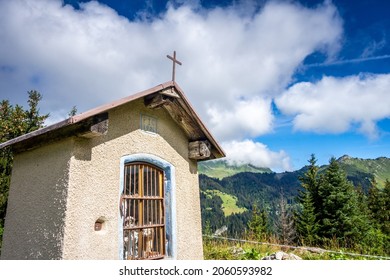 Small chapel in front of a mountain landscape. La Clusaz, France